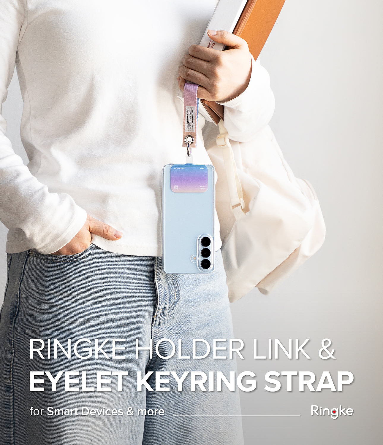 Holder Link Eyelet Keyring - A person holding a phone with a pastel gradient card holder attached to a fabric wrist strap.