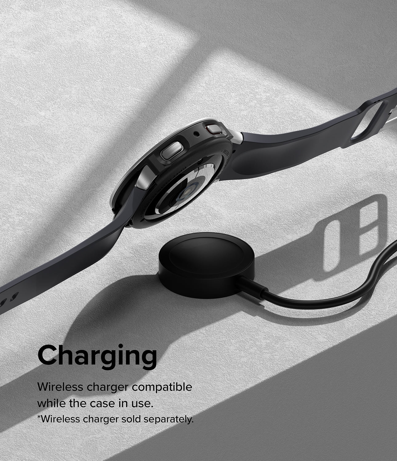 Galaxy Watch 5 44mm | Air Sports Black + Bezel Styling - Smartwatch with protective case resting on a wireless charger.