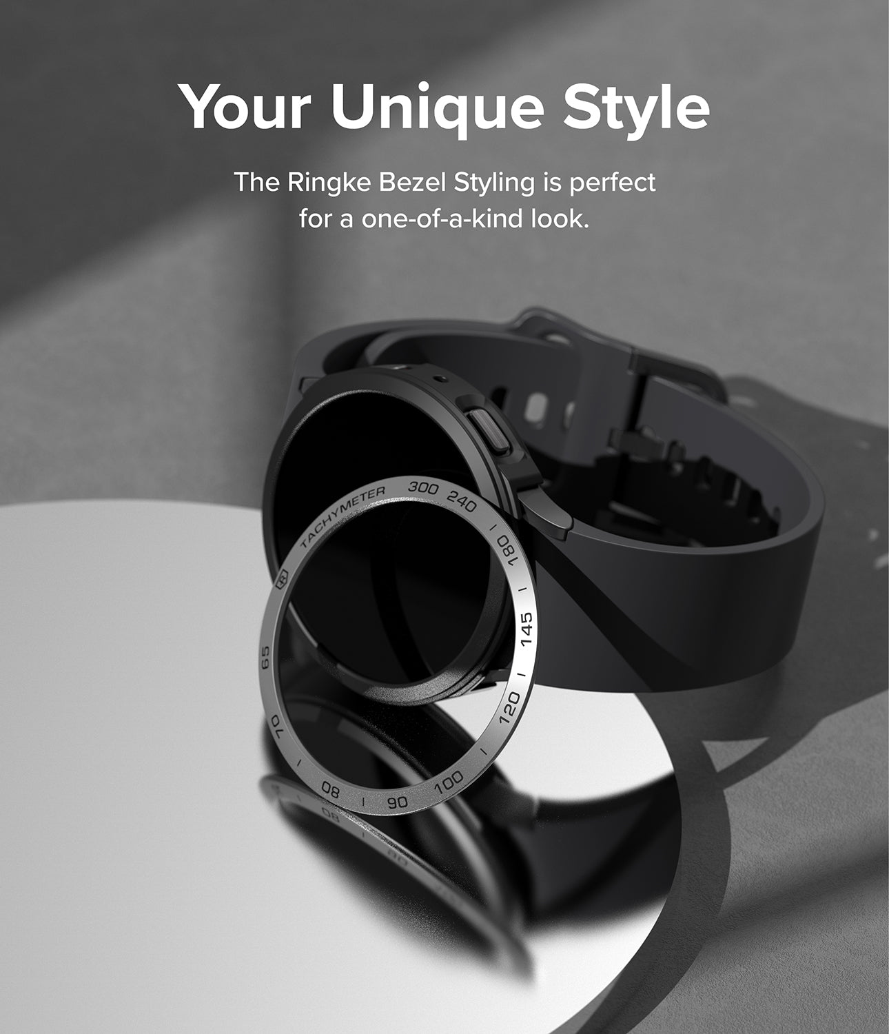 Galaxy Watch 5 44mm | Air Sports Black + Bezel Styling - Black smartwatch with tachymeter bezel ring on a mirror.