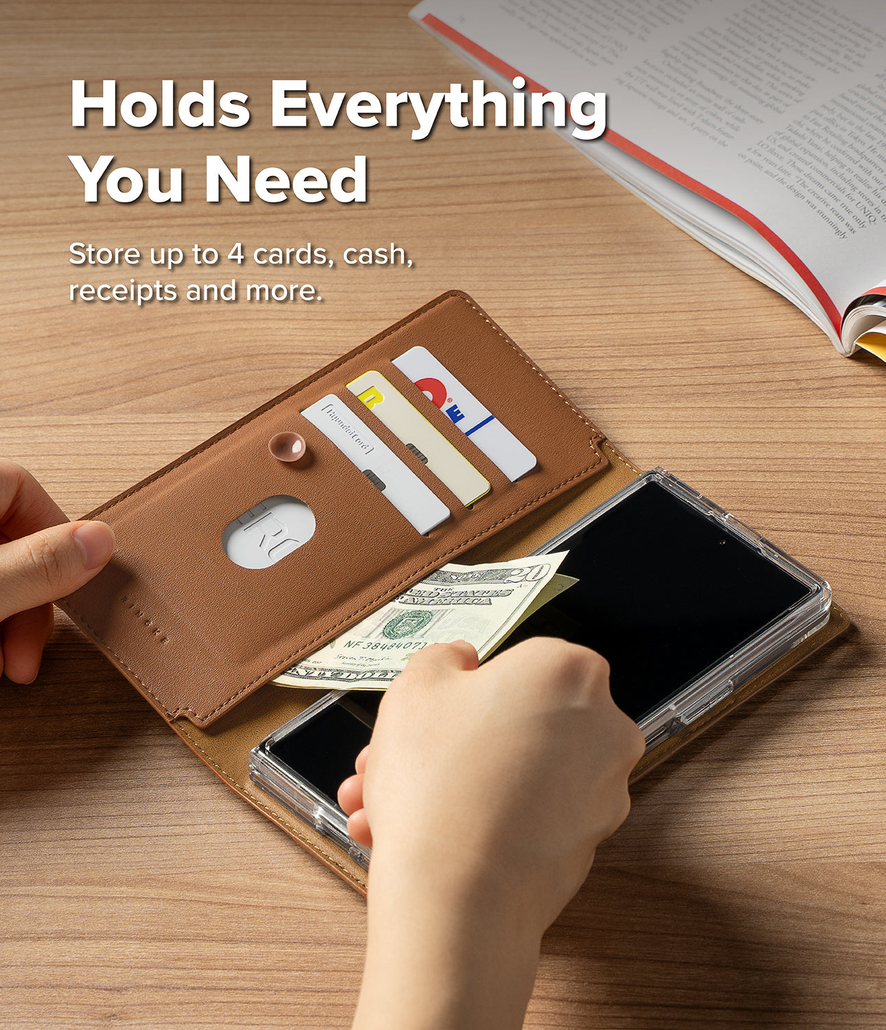 Galaxy Z Fold 8 Ultra MagSafe Wallet | Folio Grip Wallet Magnetic - A tan leather phone wallet case shown open on a wooden desk, with a phone inside and hands demonstrating card and cash storage. White text at the top reads 'Holds Everything You Need' and 'Store up to 4 cards, cash, receipts and more.