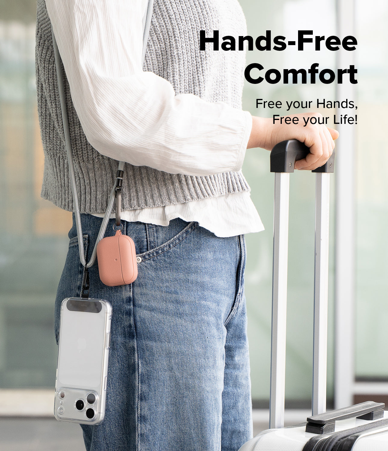 Holder Link Strap | Black - Person wearing a crossbody strap holding a phone and pink earbud case while pulling luggage.