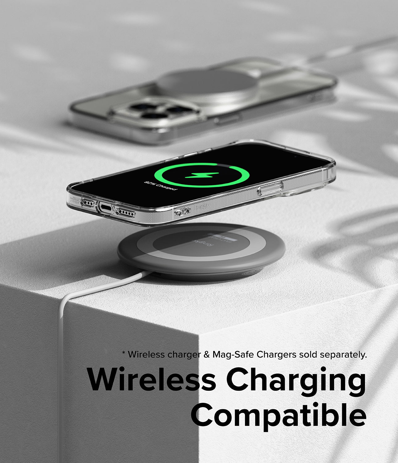 iPhone 15 Pro Case | Air - Clear phone case on a wireless charging pad showing a green charging icon on the screen.