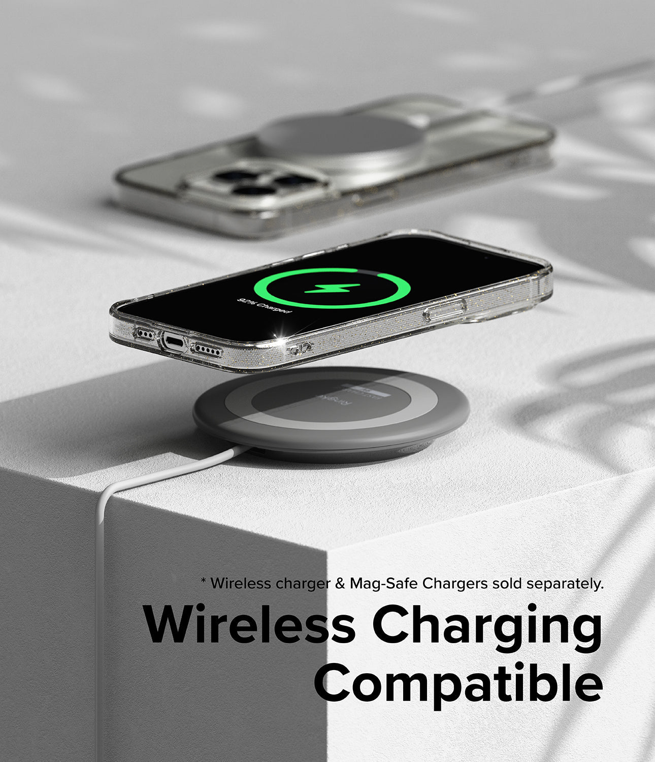 iPhone 15 Pro Case | Air - iPhone 15 Pro in a clear case wirelessly charging on a grey pad with a green charging icon displayed.