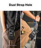 Person wearing a rope hand strap iPhone 17 pro max case with dual strap holes, holding a ladder.