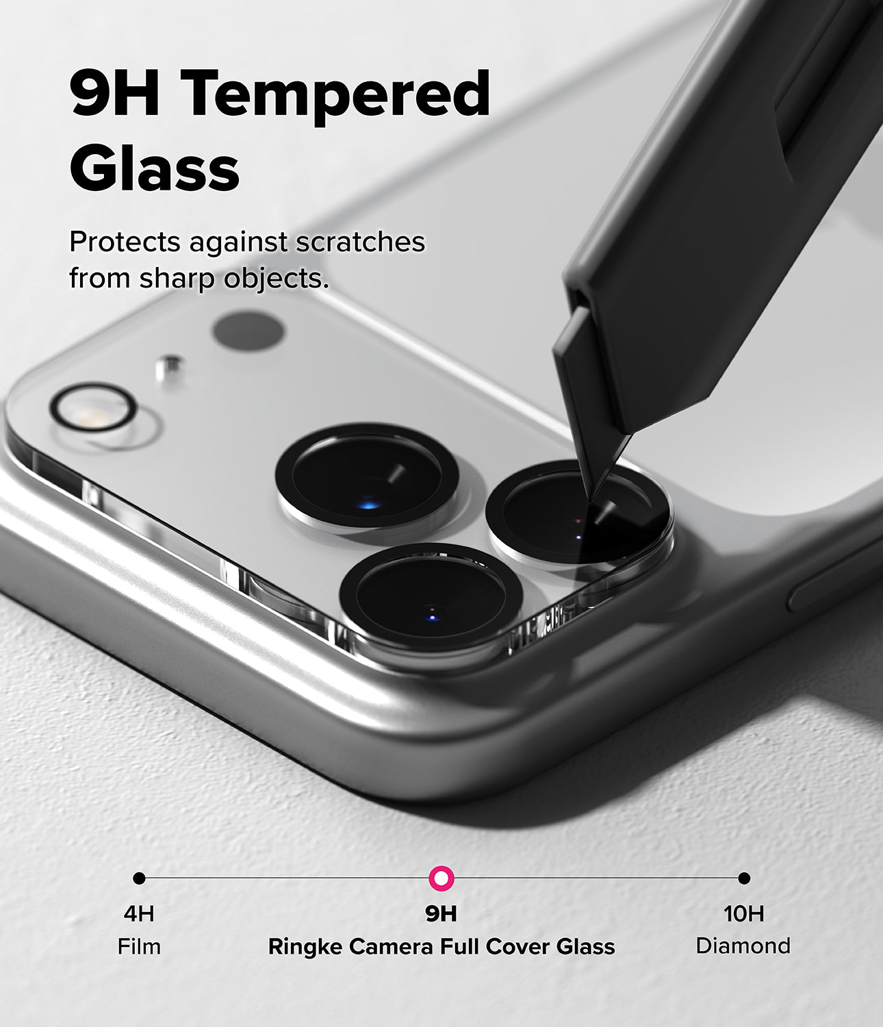 iPhone 17 Pro | Camera Glass - A utility knife blade presses against a 9H tempered glass camera lens protector on a smartphone.