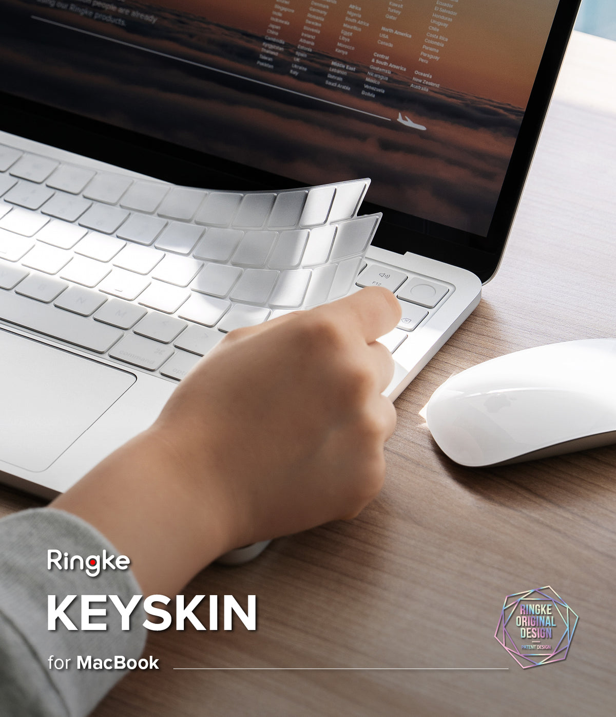 MacBook Neo | Keyskin - A hand peels back a transparent protective keyboard skin from a silver MacBook keyboard, with a white mouse on a wooden desk. Text on the image reads 'Ringke KEYSKIN for MacBook'.