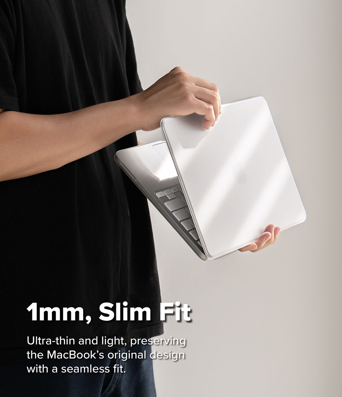 MacBook Neo Case + Protector all-groups - A person in a black shirt holds a slim white laptop closed, demonstrating its thin profile. White text at the bottom reads '1mm, Slim Fit' with additional descriptive copy about the ultra-thin and light design.