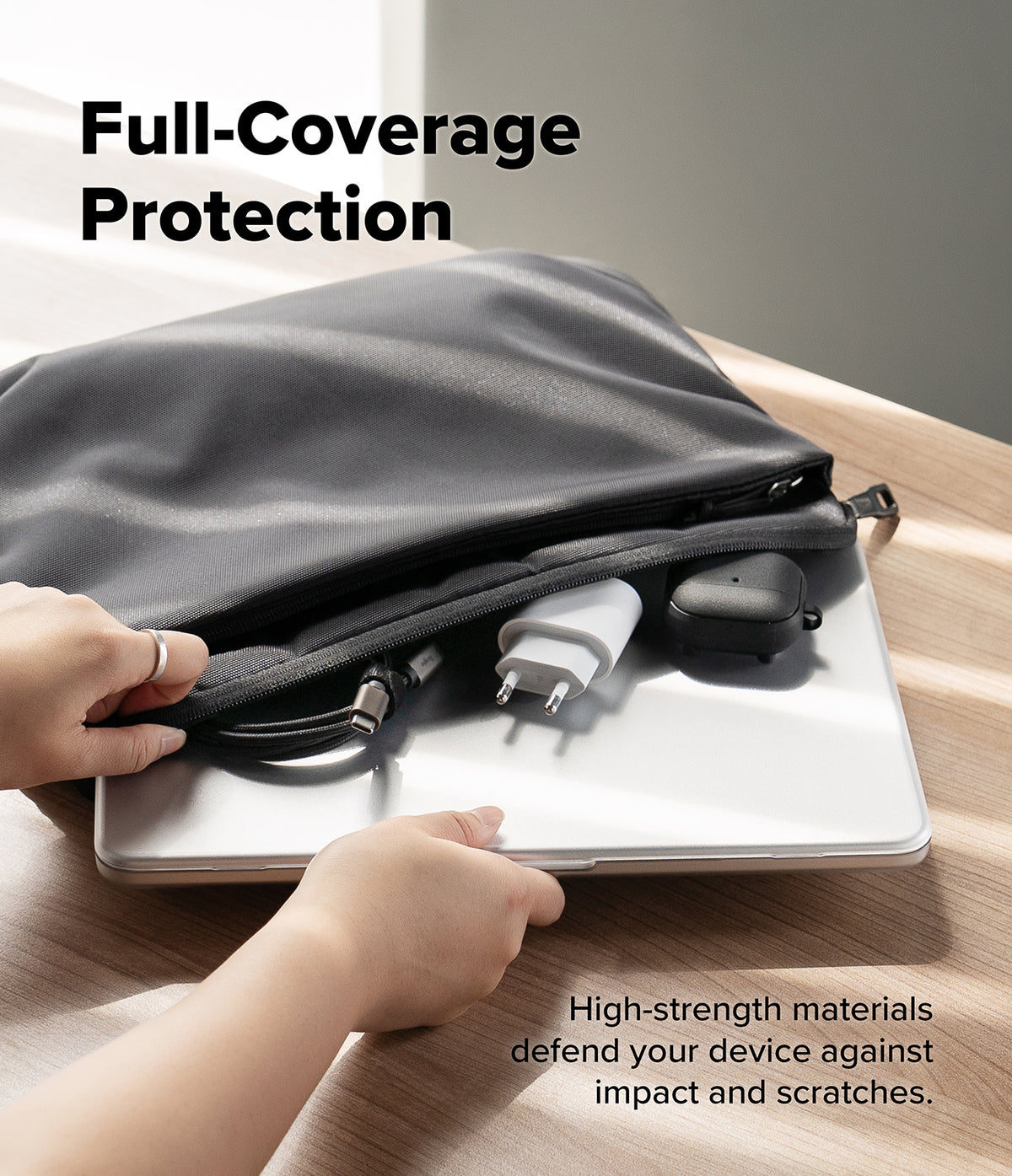 MacBook Neo Case + Protector all-groups - A black laptop sleeve with a built-in laptop protector pocket is shown on a wooden table, with hands demonstrating how to slide a laptop underneath the sleeve for full coverage. The text reads 'Full-Coverage Protection' and 'High-strength materials defend your device against impact and scratches.