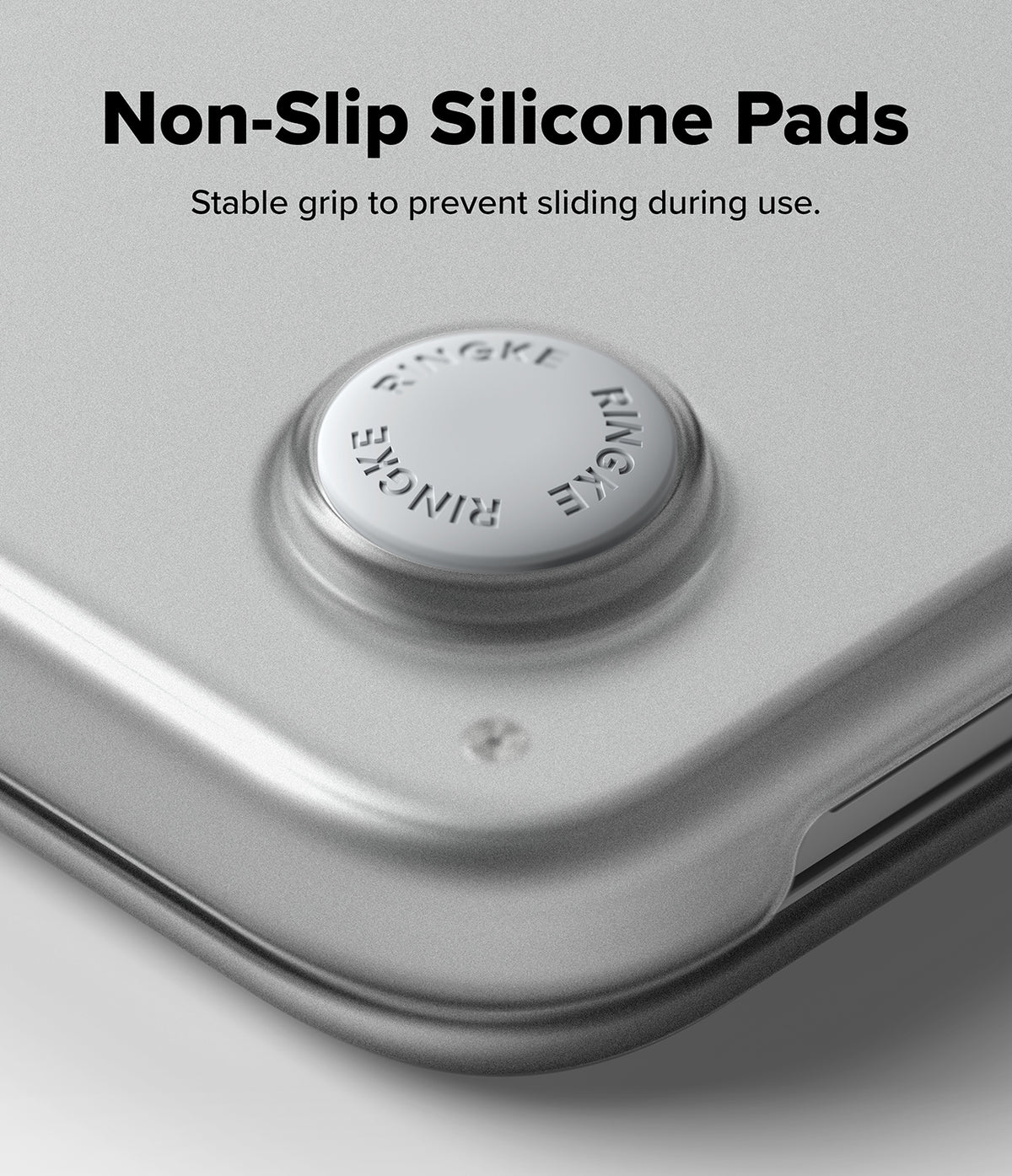 MacBook Neo | Slim - Close-up of a silver metallic device corner with a circular non-slip silicone pad, with text reading 'Non-Slip Silicone Pads' and 'Stable grip to prevent sliding during use.'.