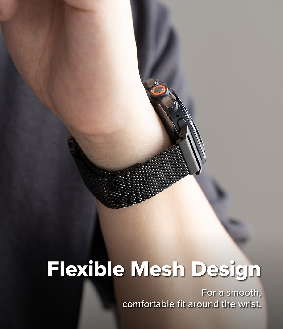 Galaxy Watch Ultra 2 / 1 | Metal One Mesh - A close-up of a person's wrist wearing a black smartwatch with a black flexible mesh band. White text at the bottom reads 'Flexible Mesh Design' with smaller text below.