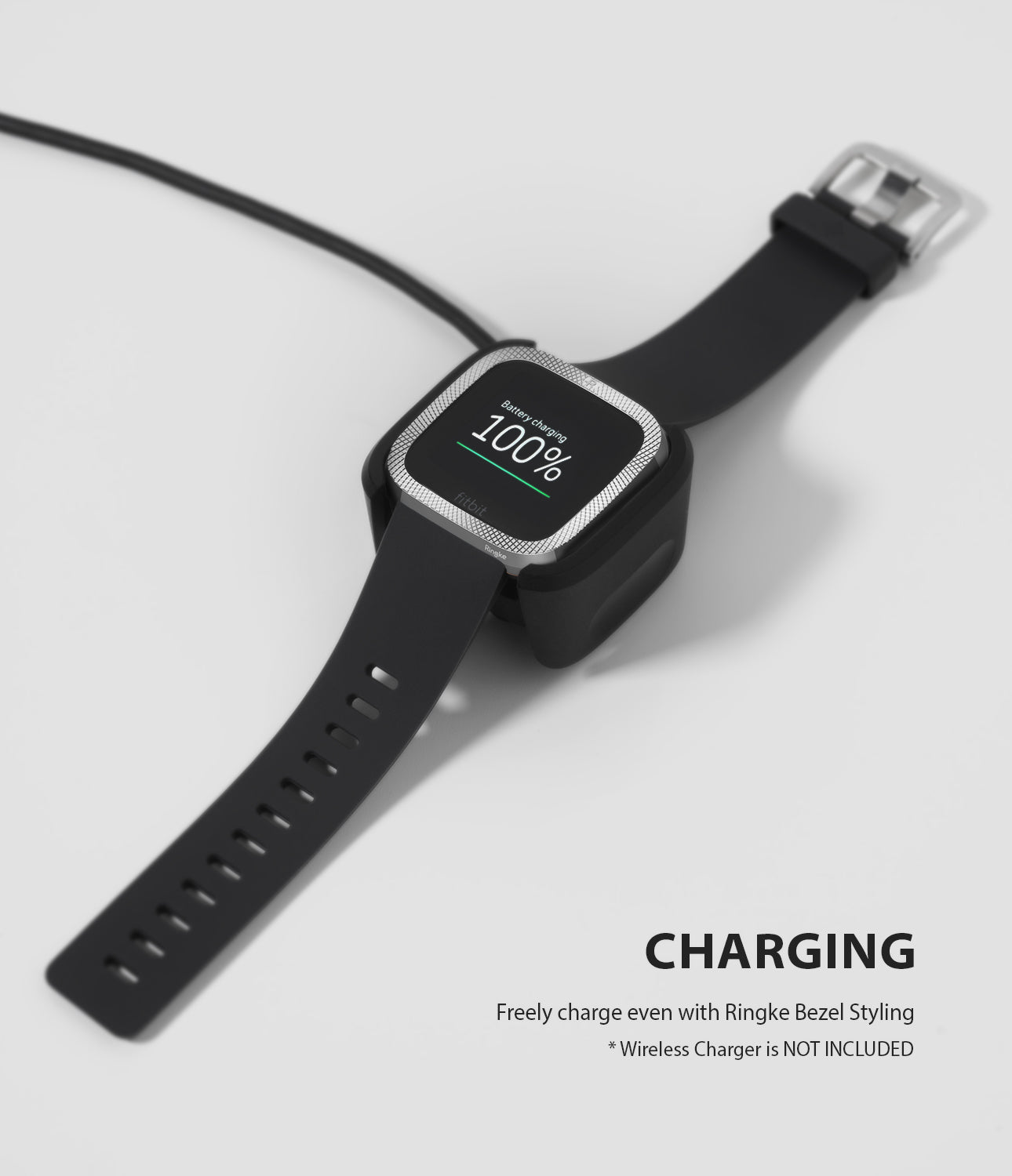 Fitbit Versa 2 | Bezel Styling 42 - A Fitbit Versa 2 with a silver textured bezel accessory charging on a black dock.
