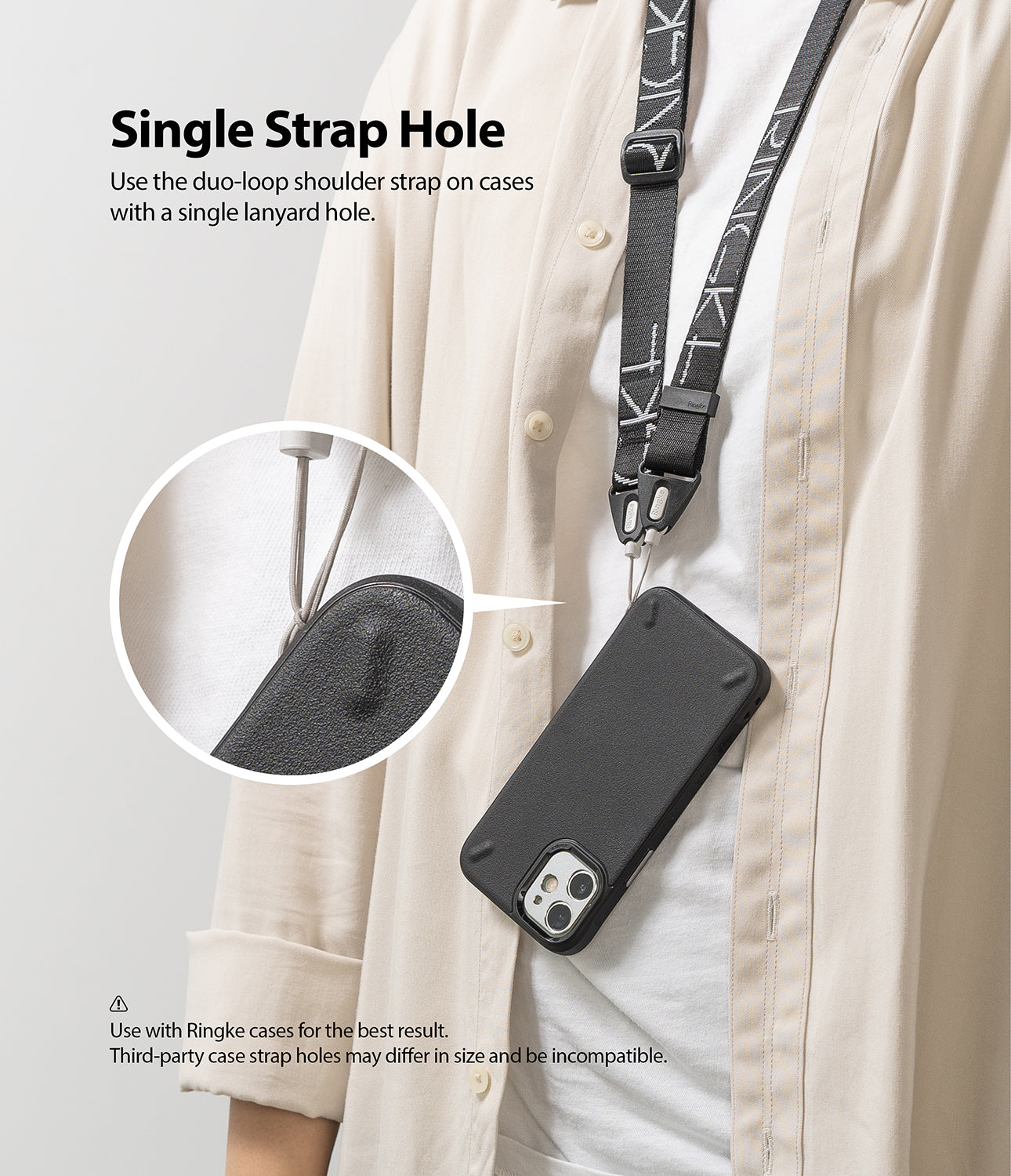 Shoulder Strap | Lettering - A person wearing a black branded shoulder strap attached to a phone case via a single lanyard hole.
