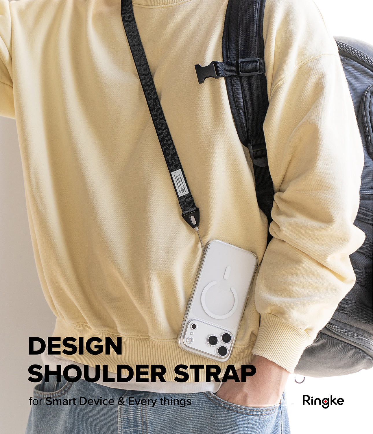 Shoulder Strap | Lettering - Person wearing a black branded shoulder strap attached to a clear phone case over a yellow sweatshirt.