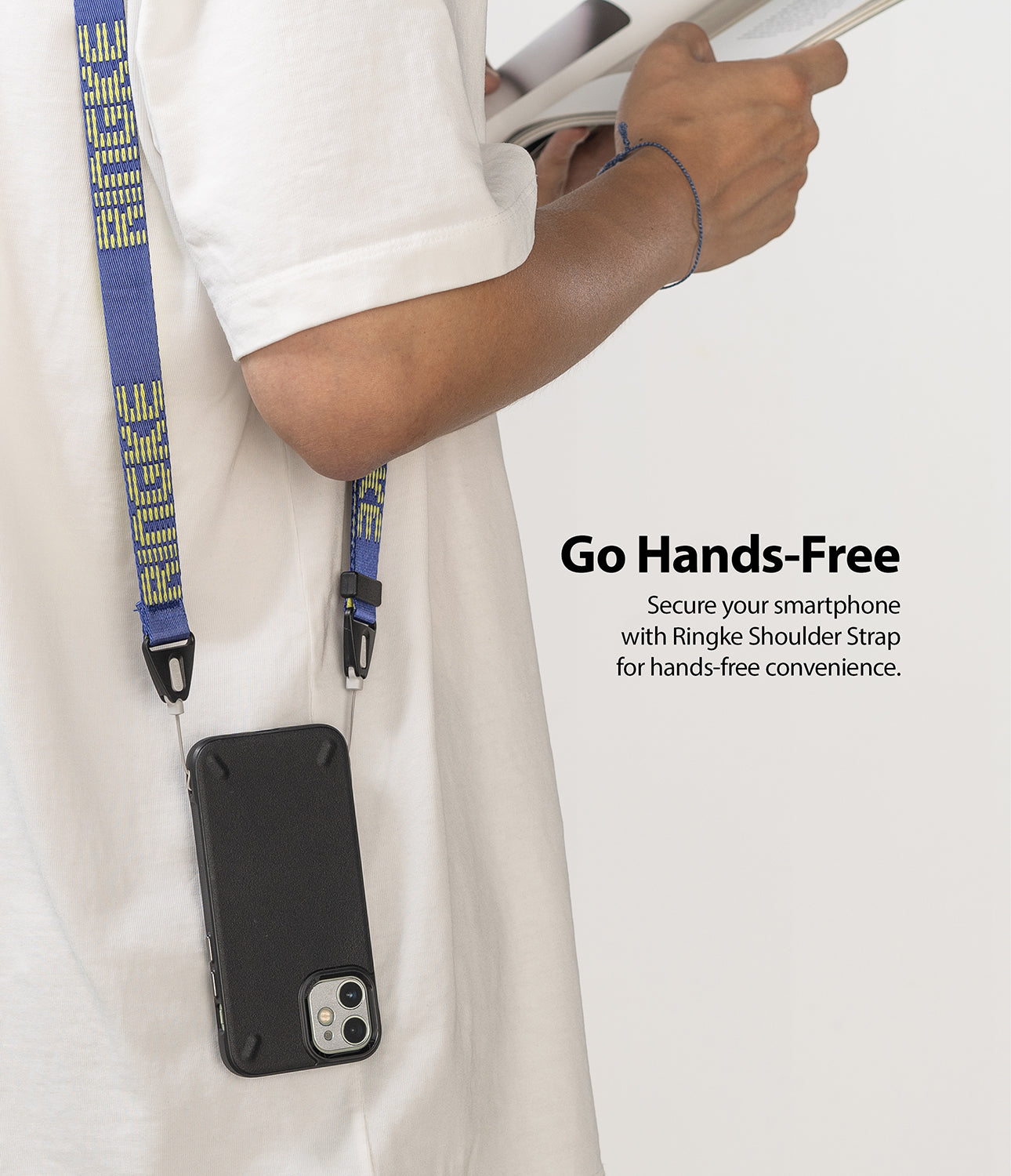 Shoulder Strap | Lettering - Person wearing a blue strap with yellow lettering attached to a black smartphone case.