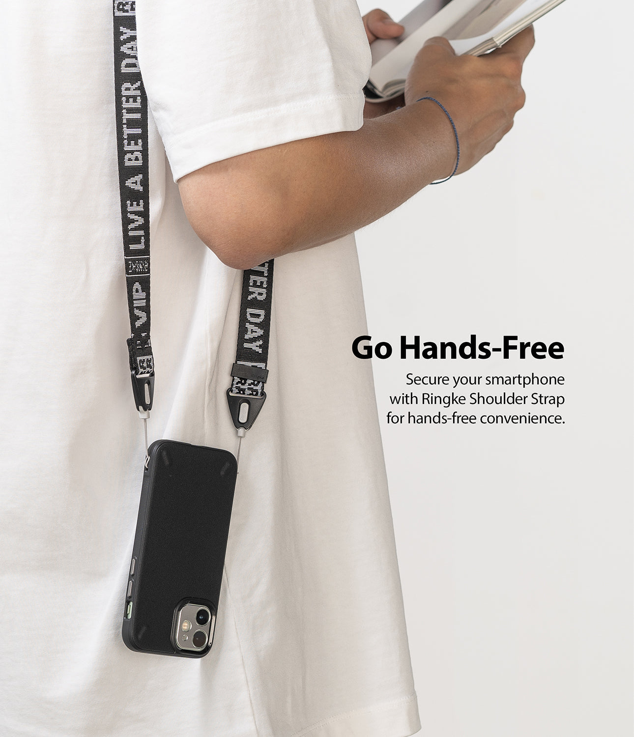 Shoulder Strap | Lettering - Person wearing a black phone case on a branded shoulder strap with white text against a white shirt.