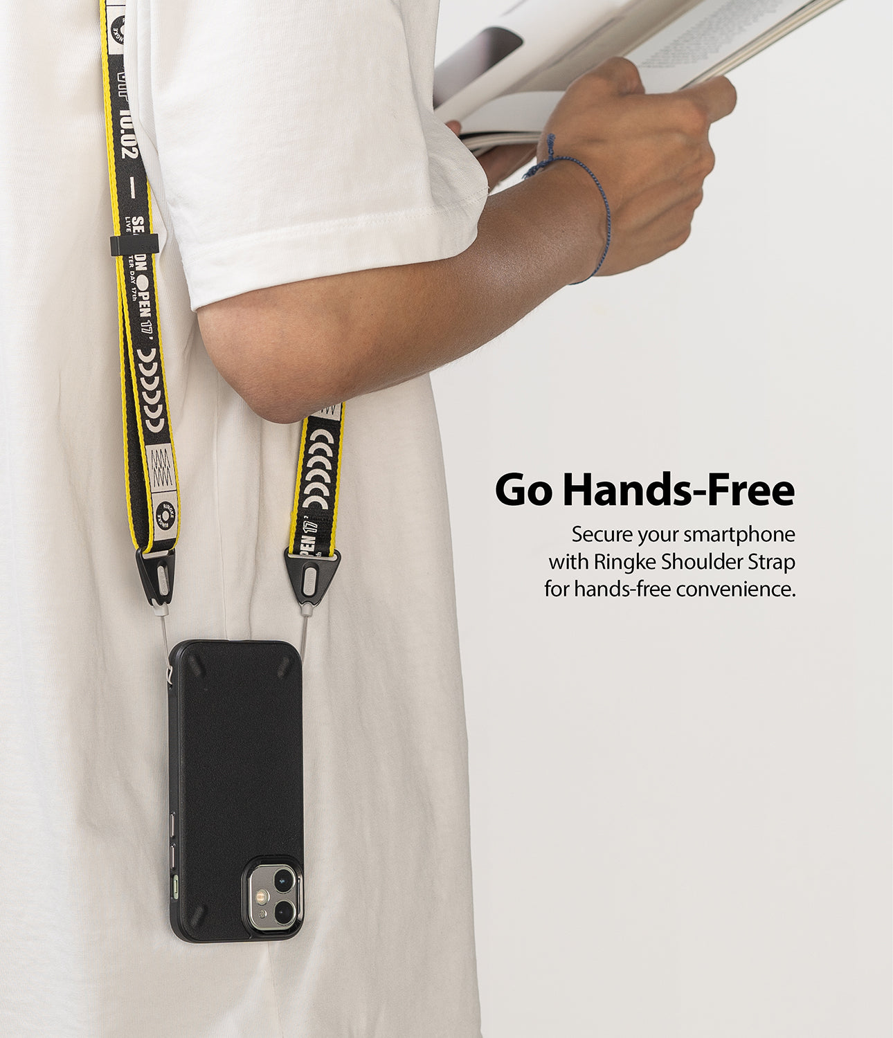 Shoulder Strap | Lettering - Person wearing a black and yellow branded shoulder strap attached to a smartphone case.