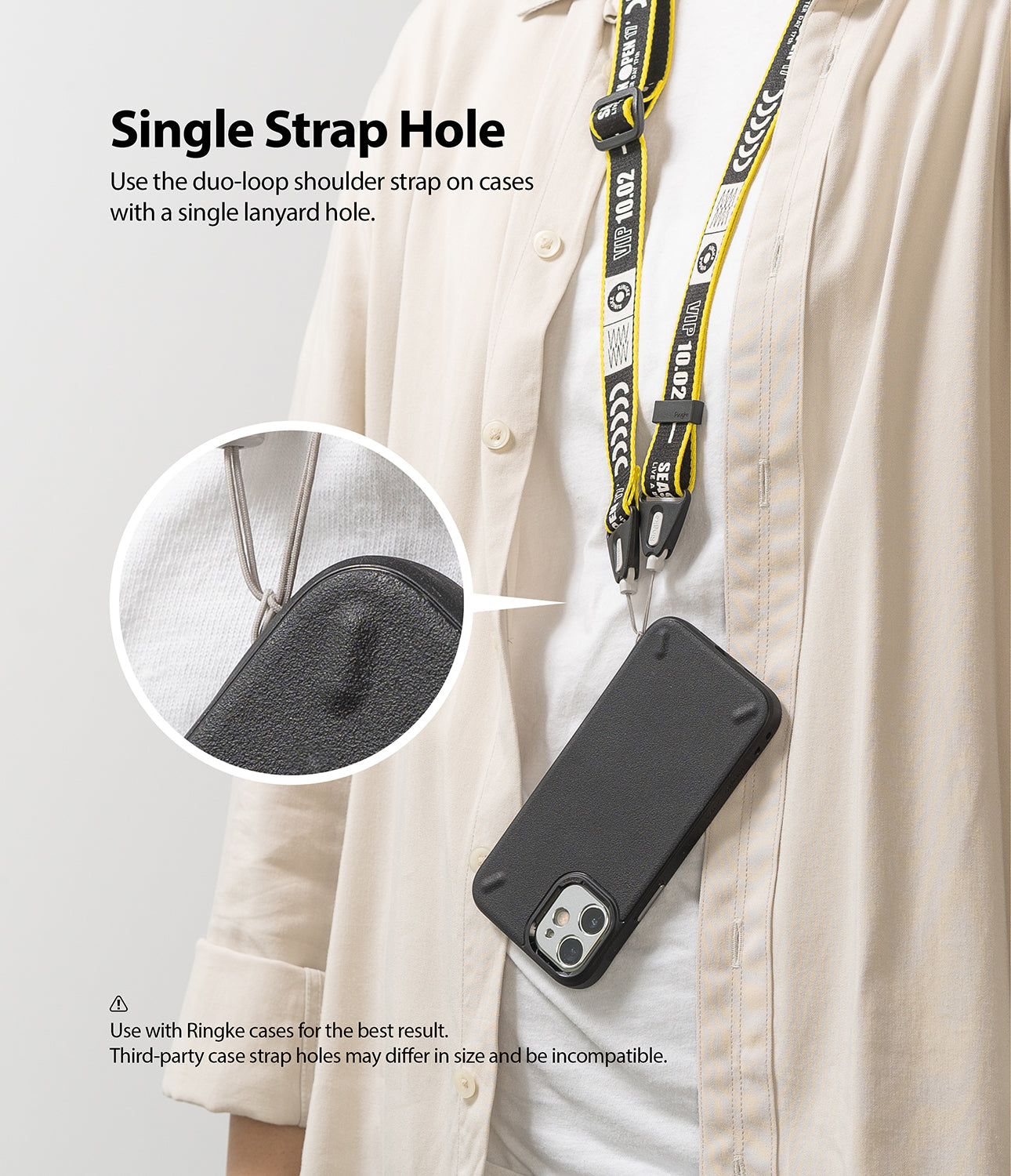 Shoulder Strap | Lettering - Person wearing a yellow and black branded shoulder strap attached to a black phone case.