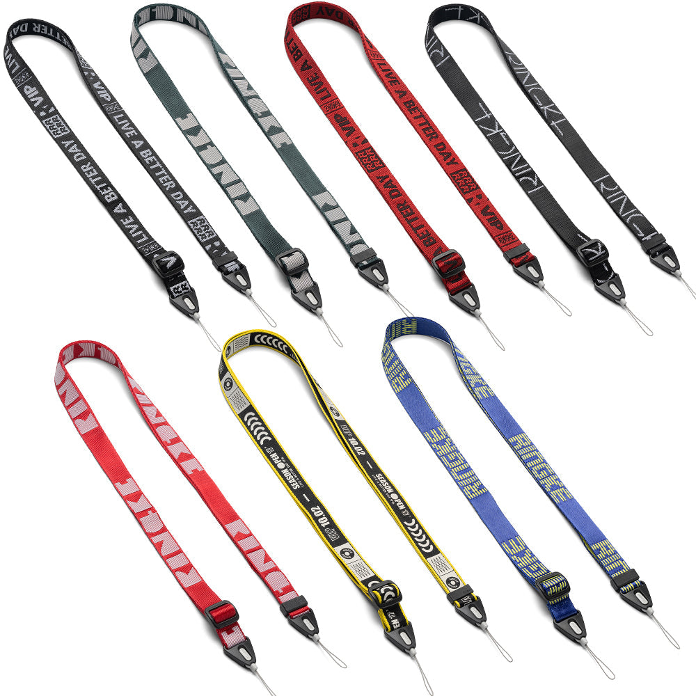 Shoulder Strap | Lettering - Seven colorful fabric camera straps with various branded text and patterns arranged on white.