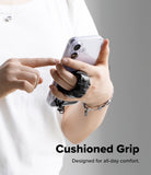 Holder Link Puffer | Finger - A person holding a phone with a black, quilted, cushioned finger strap for a secure grip.