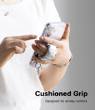 Holder Link Puffer | Finger - A person holding a phone with a sliver, quilted, cushioned finger strap for a secure grip.