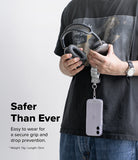 Holder Link Puffer | Finger - Person holding a phone with a puffer finger strap, wearing a black shirt with a graphic design.