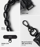 Holder Link Puffer | Hand - Black quilted polyester strap, nylon holder link, and zinc alloy 360-degree swivel carabiner.