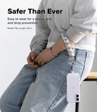Holder Link Puffer | Hand - Person wearing a lanyard with a phone holder, sitting on a chair.