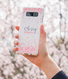 Galaxy Note 8 [Slim Cherry Blossom] [Limited Edition] - Hand holding white phone case with pink petals and script text.