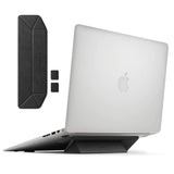 Laptop Stand - A foldable black adhesive laptop stand attached to a silver laptop, with extra pieces shown separately.