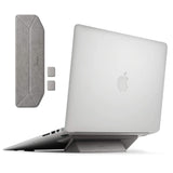 Laptop Stand - A grey foldable adhesive laptop stand attached to the base of a silver laptop, with extra pads shown.
