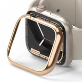 Apple Watch 9 / 8 / 7 (41mm) | Bezel Styling - A rose gold metallic bezel cover hovering over a beige Apple Watch.
