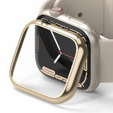 Apple Watch 9 / 8 / 7 (41mm) | Bezel Styling - Gold adhesive bezel frame hovering above a beige Apple Watch.