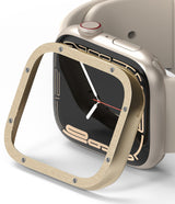 Apple Watch 9 / 8 / 7 (41mm) | Bezel Styling Premium - Gold brushed metal bezel cover hovering over a beige Apple Watch.