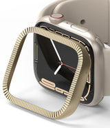 Apple Watch 9 / 8 / 7 (41mm) | Bezel Styling Premium - Gold fluted bezel accessory hovering over a starlight Apple Watch.