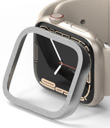 Apple Watch 9 / 8 / 7 (41mm) | Bezel Styling Premium - Brushed silver metal bezel cover hovering over a beige Apple Watch.