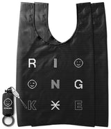 Day-Me Bag - Black reusable tote with white pixelated text and icons, shown unfolded and as a small, clipped pouch.