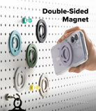 Dual Magnetic Silicone Ring - A hand attaches a phone with a purple magnetic ring to a matching ring mounted on a pegboard.