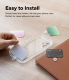 Holder Link Eyelet Keyring - Hand placing a thin, colorful strap anchor into a clear phone case on a wooden surface.