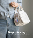 Holder Link Eyelet Keyring - A person holding a white corduroy bag with a pastel gradient fabric keyring attached to the zipper.