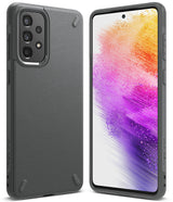 Galaxy A73 5G Case | Onyx - Matte black textured phone case for Galaxy A73 5G on a dark surface with branding and earbuds.