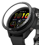Forerunner 265 | Bezel Styling - A black Garmin smartwatch with a detached, textured metal bezel ring hovering above the display.