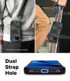 Google Pixel 10a Case | Onyx - Onyx camo phone case with dual strap holes shown worn on a lanyard and held near a ladder.