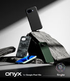Google Pixel 10a Case | Onyx - Three Google Pixel 10a phone cases in black, camo, and green displayed on jagged rocks.