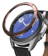 Galaxy Watch 3 (41mm) | Bezel Styling - A metallic bronze bezel ring hovering above a silver Galaxy Watch 3 with a black leather strap.