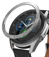 Galaxy Watch 3 (45mm) | Bezel Styling - A silver metallic bezel ring hovering above a Galaxy Watch 3 with a black leather strap.