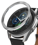 Galaxy Watch 3 (45mm) | Bezel Styling - A silver, textured metal bezel ring hovering above a Galaxy Watch 3 smartwatch.