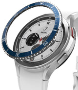 Galaxy Watch 4 Classic 42mm | Bezel Styling - Four smartwatches with different colored bezel rings displayed on concrete.