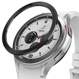 Galaxy Watch 4 Classic 42mm | Bezel Styling - Silver and black watch bezels displayed on a black stand with a watch.