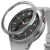 Galaxy Watch 4 Classic 46mm | Bezel Styling - Smartwatches with metallic bezel covers displayed on a black stand.