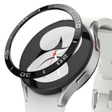 Galaxy Watch 5/4 40mm | Bezel Styling - A black adhesive watch bezel ring hovering above a silver smartwatch with a white band.